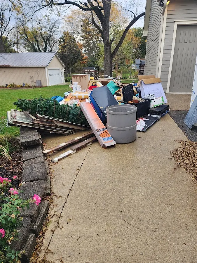 Dumpster being loaded with debris for Estate Cleanout Dumpster Rental in West Long Branch